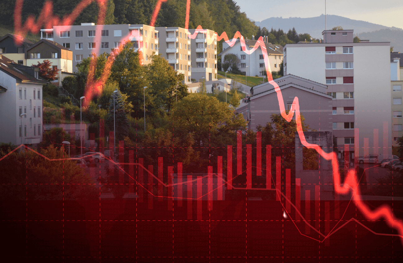 Rote Zinslinie im Vordergrund, Wohnblöcke im Hintergrund.